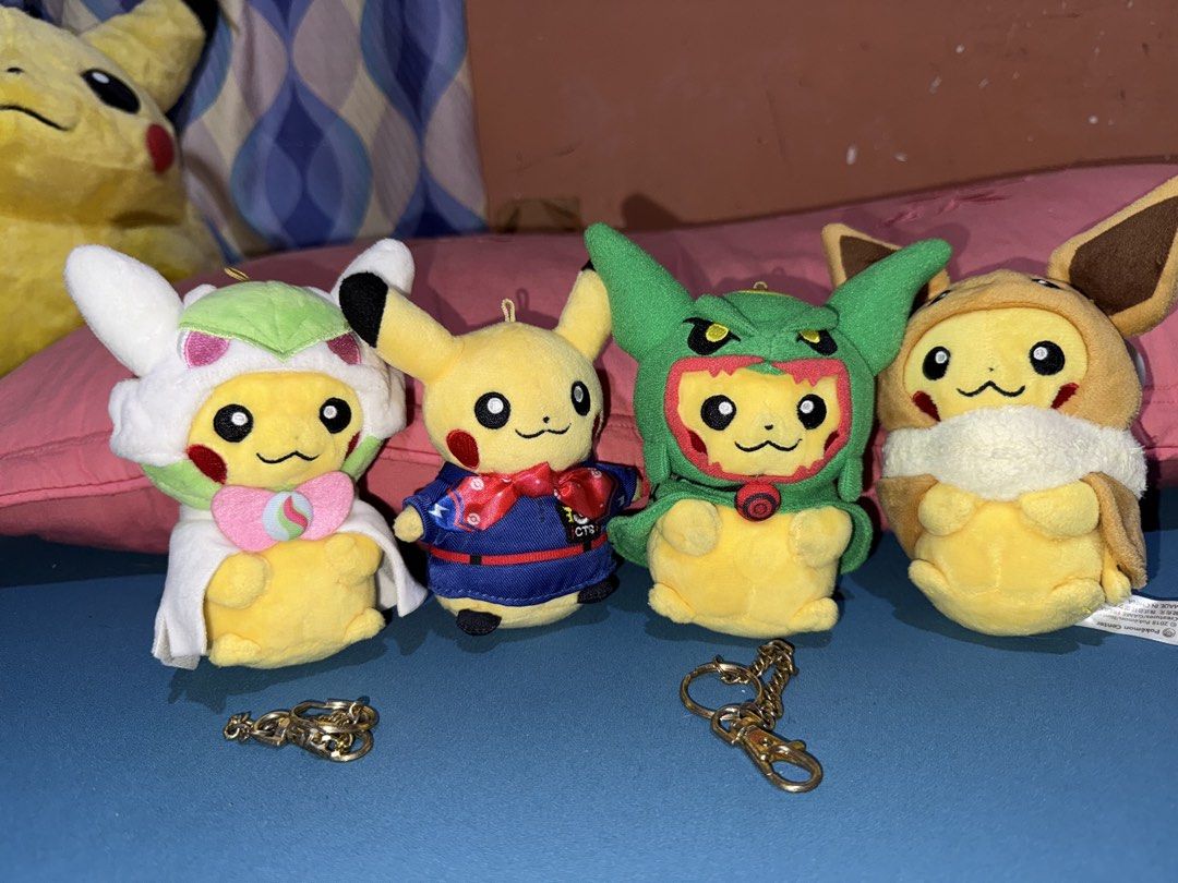 Pokemon Center BUNDLE Pikachu Costume Plush Keychains (Category: Plushies & Soft Toys) located in Ozamiz City. Submitted by clickerx (Listing ID 1469947392, Image 1). Description: - Set of 4 Pikachu plush keychains in unique costumes - Costumes included: Gardevoir, Rayquaza, Eevee, and traditional festival outfit - Made with ultra-soft fabric and high-quality embroidered facial details - Includes detachable gold-tone keychains for two of the plus