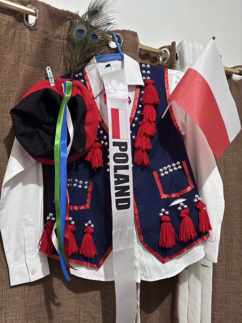POLAND Traditional Costume UN (Category: Babies & Kids Fashion) located in Quezon City. Submitted by thezzzagm (Listing ID 1470117929, Image 1). Description: ✨ UN POLAND COSTUME ✨ - Authentic traditional Polish folk costume for boys - Set includes: dark blue vest with red tassels and metallic bead accents, red and white striped pants, and a decorative hat with colorful ribbons and a peacock feather - Condition: Worn only once, like new - Ideal fo