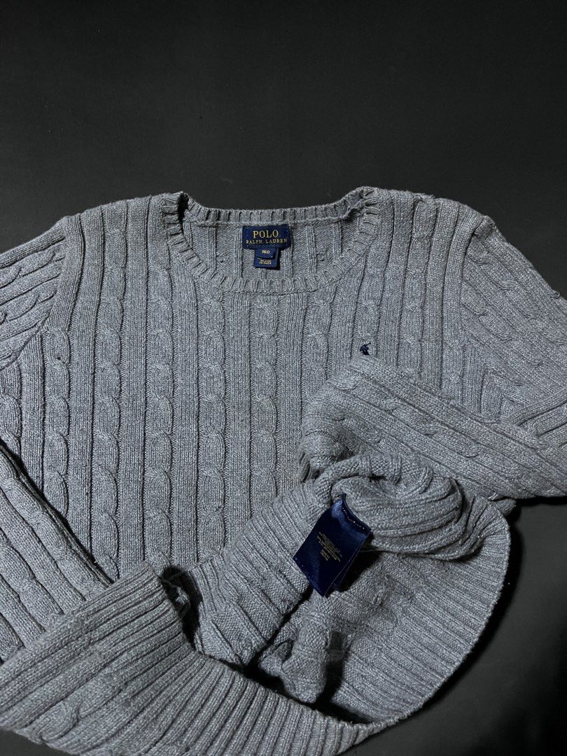 Polo Ralph Lauren Gray Cable Knit Sweater (Category: Longsleeves) located in Andop. Submitted by outclickz_00 (Listing ID 1470119957, Image 2). Description: - Brand: Polo Ralph Lauren - Color: Gray - Size: Small 17/22 - Material: Wool/cotton blend with classic cable knit texture - Design: Crewneck, long sleeves, ribbed cuffs, and signature embroidered pony logo - Condition: Clean with standard light wear around the neckline and cuffs - Perfect fo