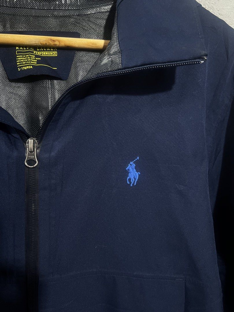 Polo Ralph Lauren Performance Navy Windbreaker Jacket Size S (Category: Coats, Jackets and Outerwear) located in Manila. Submitted by dwyaneallen (Listing ID 1470003555, Image 3). Description: - Brand: Polo Ralph Lauren Performance - Item: Lightweight hooded windbreaker jacket - Color: Solid navy blue - Size: Small (170/92A) - Material: 100% polyester shell - Details: Full zip closure, YKK hardware, hood drawstrings, signature embroidered blue po