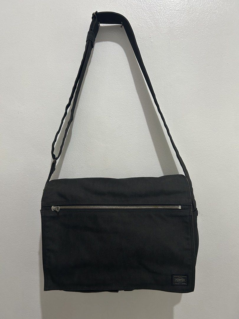 Porter Yoshida & Co. Black Messenger Bag (Category: Sling Bags) located in Angeles City. Submitted by cassey_phoenix (Listing ID 1469966117, Image 1). Description: - Authentic Porter Yoshida & Co. messenger bag from Tokyo, Japan - Crafted from durable black canvas fabric with an adjustable shoulder strap - Secure flap closure with velcro strips and a convenient front zippered pocket - Two open utility pockets located underneath the main flap - Fe
