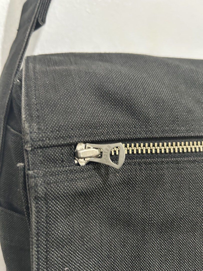 Porter Yoshida & Co. Black Messenger Bag (Category: Sling Bags) located in Angeles City. Submitted by cassey_phoenix (Listing ID 1469966117, Image 3). Description: - Authentic Porter Yoshida & Co. messenger bag from Tokyo, Japan - Crafted from durable black canvas fabric with an adjustable shoulder strap - Secure flap closure with velcro strips and a convenient front zippered pocket - Two open utility pockets located underneath the main flap - Fe