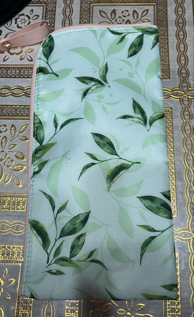 Pouch and scarf set (Category: Purses & Pouches) located in Bacoor. Submitted by ayit. (Listing ID 1470062717, Image 2). Description: Sf inc pouch new scarf once used japan gling personal - Includes: 1 botanical print pouch and 1 patterned scarf - Pouch features: Green leaf pattern, pink zipper, hand strap, L'Occitane brand tag, and soft fluffy white inner lining - Scarf features: Vibrant yellow color with blue and grey rope/chain design - Perfec