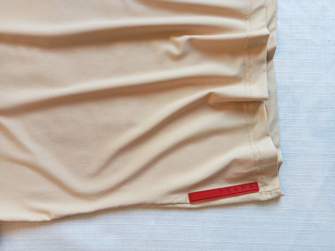 Prada beige short sleeve redtab top (Category: Luxury Apparel) located in Bagabag. Submitted by thrift_stories96 (Listing ID 1470127257, Image 3). Description: Prada beige short sleeve redrab top Medium Length - 22 Width - 17 stretch up to 18 Cloth material - cotton spandex Condition - excellent No flaw.