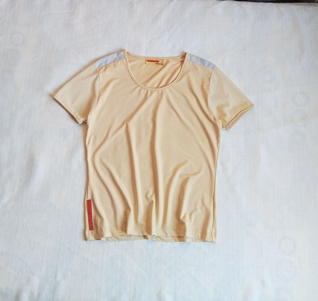 Prada beige short sleeve redtab top (Category: Luxury Apparel) located in Bagabag. Submitted by thrift_stories96 (Listing ID 1470127257, Image 1). Description: Prada beige short sleeve redrab top Medium Length - 22 Width - 17 stretch up to 18 Cloth material - cotton spandex Condition - excellent No flaw.