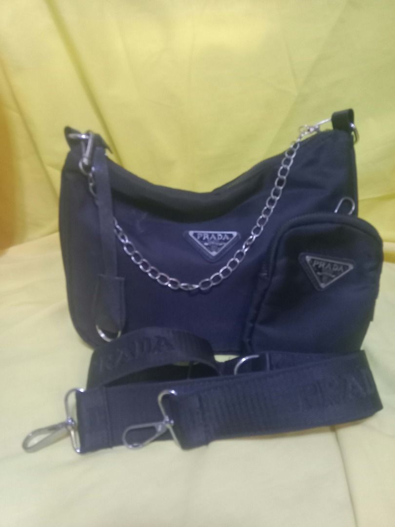 Black Nylon Re-Edition Shoulder Bag Set (Category: Luxury Bags & Wallets) located in Quezon City. Submitted by honeyonline.ph (Listing ID 1470102983, Image 2). Description: ✨ FOR SALE ✨ Elevate your everyday look with this chic black shoulder bag! Features a sleek design, silver chain detail, detachable pouch, and adjustable strap. 🖤 Classic black color 🖤 Lightweight and practical 🖤 Matches any outfit 🖤 Great for daily use 💰 Asking Price: ₱3