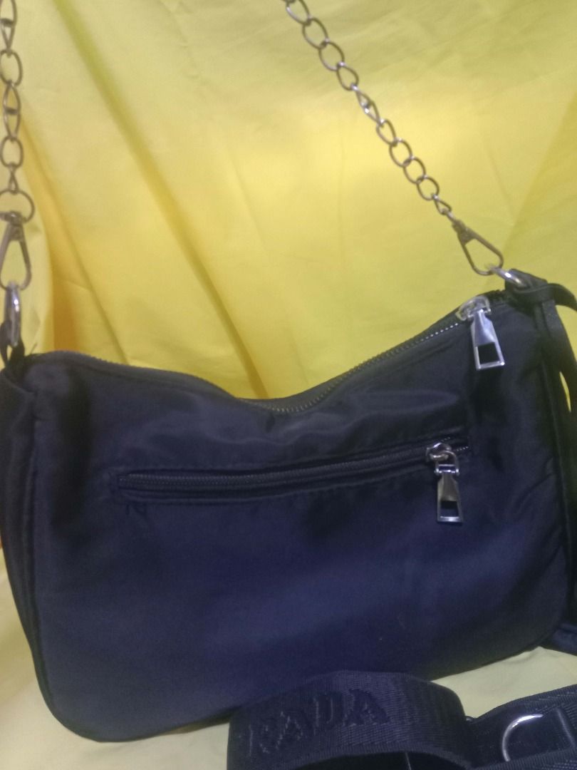 Black Nylon Re-Edition Shoulder Bag Set (Category: Luxury Bags & Wallets) located in Quezon City. Submitted by honeyonline.ph (Listing ID 1470102983, Image 3). Description: ✨ FOR SALE ✨ Elevate your everyday look with this chic black shoulder bag! Features a sleek design, silver chain detail, detachable pouch, and adjustable strap. 🖤 Classic black color 🖤 Lightweight and practical 🖤 Matches any outfit 🖤 Great for daily use 💰 Asking Price: ₱3
