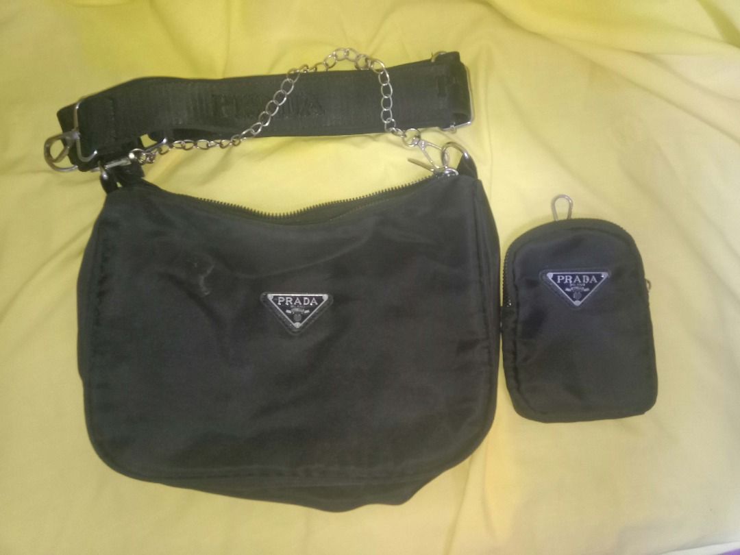 Black Nylon Re-Edition Shoulder Bag Set (Category: Luxury Bags & Wallets) located in Quezon City. Submitted by honeyonline.ph (Listing ID 1470102983, Image 1). Description: ✨ FOR SALE ✨ Elevate your everyday look with this chic black shoulder bag! Features a sleek design, silver chain detail, detachable pouch, and adjustable strap. 🖤 Classic black color 🖤 Lightweight and practical 🖤 Matches any outfit 🖤 Great for daily use 💰 Asking Price: ₱3