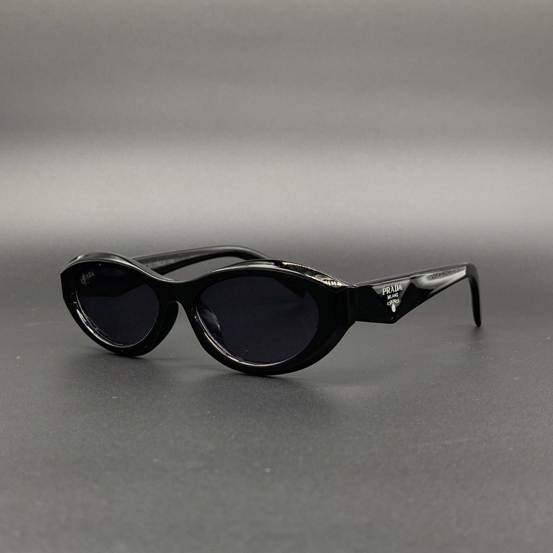 Prada Black Sunglasses Model 6135 (Category: Sunglasses & Eyewear) located in Marikina City. Submitted by see.rich.be.rich (Listing ID 1470001893, Image 1). Description: Prada black sunglasses with oval frames. Model 6135, measurements 56-15-145 on the temple arm. Glossy black finish. Distinct Prada triangular logo on both sides. Dark lenses block sun well. Made in Italy text stamped inside. Clean condition, zero scratches noticed on the glass. G