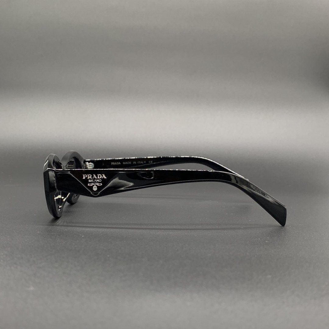 Prada Black Sunglasses Model 6135 (Category: Sunglasses & Eyewear) located in Marikina City. Submitted by see.rich.be.rich (Listing ID 1470001893, Image 3). Description: Prada black sunglasses with oval frames. Model 6135, measurements 56-15-145 on the temple arm. Glossy black finish. Distinct Prada triangular logo on both sides. Dark lenses block sun well. Made in Italy text stamped inside. Clean condition, zero scratches noticed on the glass. G
