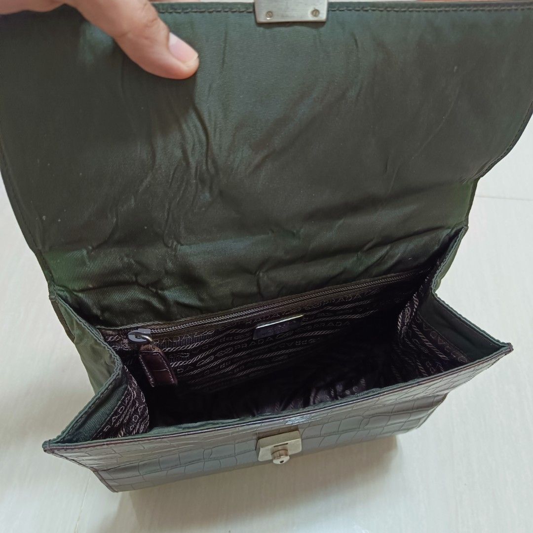 Prada Brown Crocodile Leather Handbag (Category: Luxury Bags & Wallets) located in Nasugbu. Submitted by staffpicks1515 (Listing ID 1470092378, Image 2). Description: - Brand: Prada - Material: Brown crocodile leather with Prada fabric lining - Condition: Very good overall structure with normal signs of usage - Flaws & Fixes: Minor peeling on the side top edge; handle features a colorful scarf wrapped to cover peeling leather underneath - Hardwar