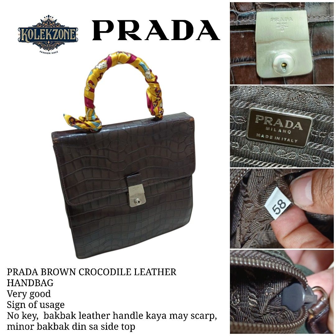 Prada Brown Crocodile Leather Handbag (Category: Luxury Bags & Wallets) located in Nasugbu. Submitted by staffpicks1515 (Listing ID 1470092378, Image 1). Description: - Brand: Prada - Material: Brown crocodile leather with Prada fabric lining - Condition: Very good overall structure with normal signs of usage - Flaws & Fixes: Minor peeling on the side top edge; handle features a colorful scarf wrapped to cover peeling leather underneath - Hardwar