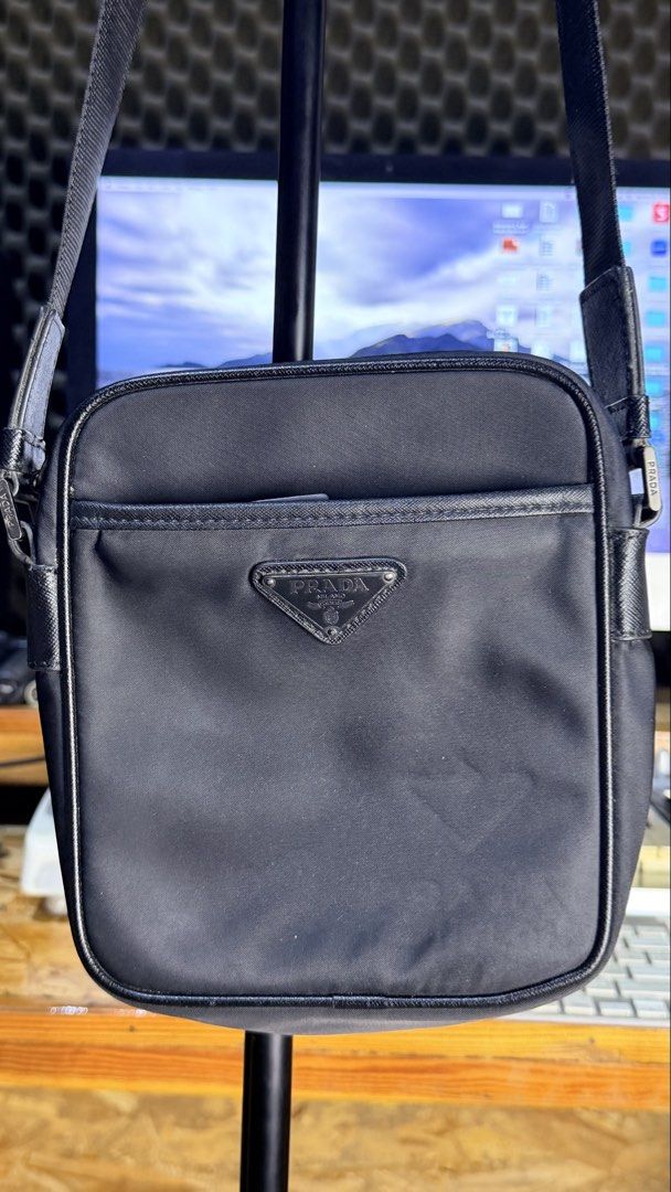 Prada nylon messenger crossbody bag black (Category: Luxury Bags & Wallets) located in Caloocan City. Submitted by prof_music1979 (Listing ID 1470094881, Image 1). Description: Black Prada crossbody bag. Iconic triangle logo on the front pocket. Zip closure on top, adjustable shoulder strap. Inside lining has the signature jacquard pattern. Made in Italy label inside. Good size for daily essentials like phone, wallet, and keys. Clean black nylon 