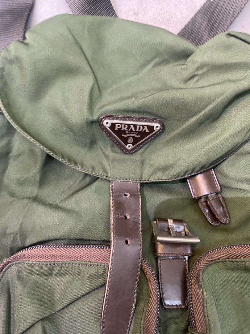 Prada nylon vintage green backpack (Category: Backpacks) located in Manila. Submitted by 5treetw3ar (Listing ID 1470003347, Image 2). Description: - Authentic green Prada nylon backpack - Chic brown leather straps with secure buckle closure - Iconic enamel triangle logo plaque on the front - Practical front zipped pockets for easy access - Adjustable webbing shoulder straps for comfort - Premium metal hardware details throughout - Spacious interi