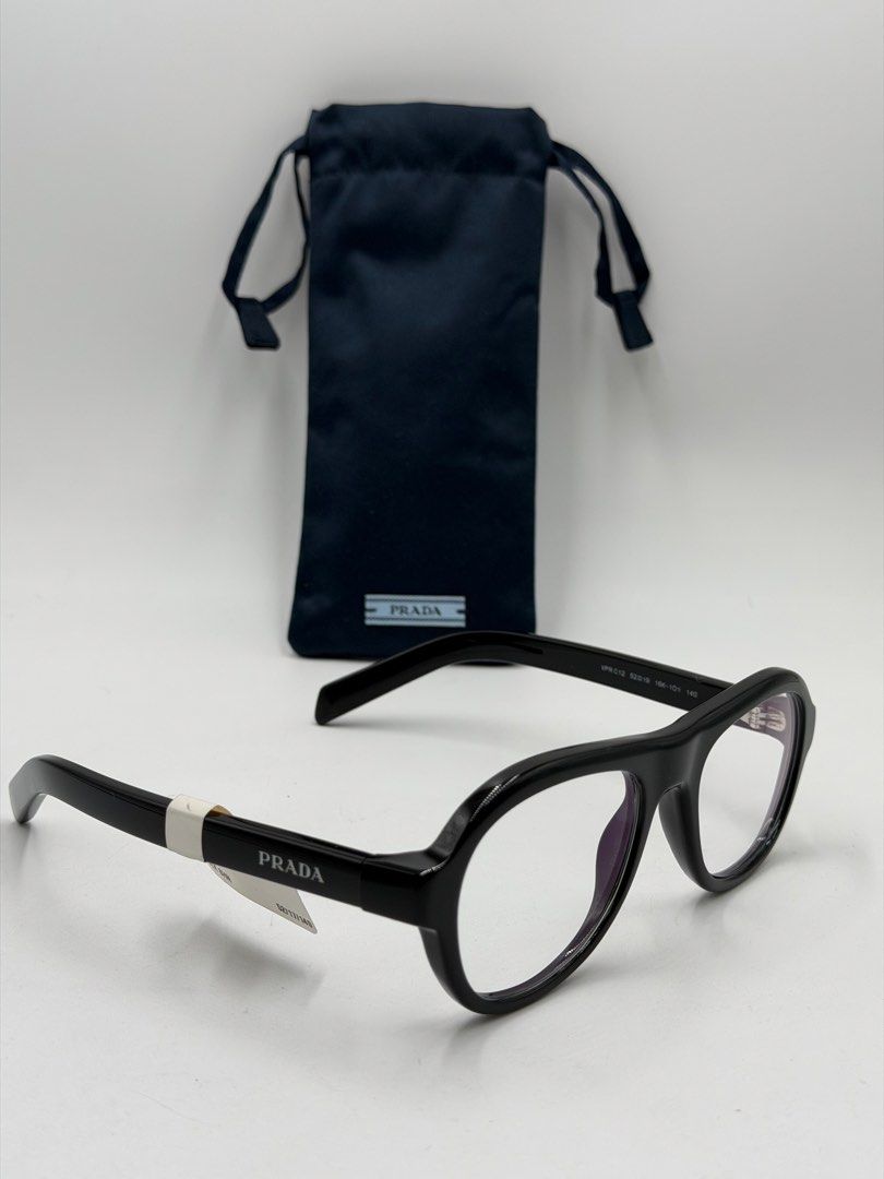 Prada PR C12V (VPRC12) eyeglasses, (Category: Activewear) located in Lipa City. Submitted by _cmluxephilippines (Listing ID 1470017579, Image 1). Description: Prada PR C12V (VPRC12) eyeglasses, • Design: A modern pillow or aviator/pilot-inspired shape that balances sharp structure with fluid, rounded curves. • Material: Crafted entirely from lightweight and durable polished black acetate. • Details: Subtle, elegant Prada logo lettering engraved a