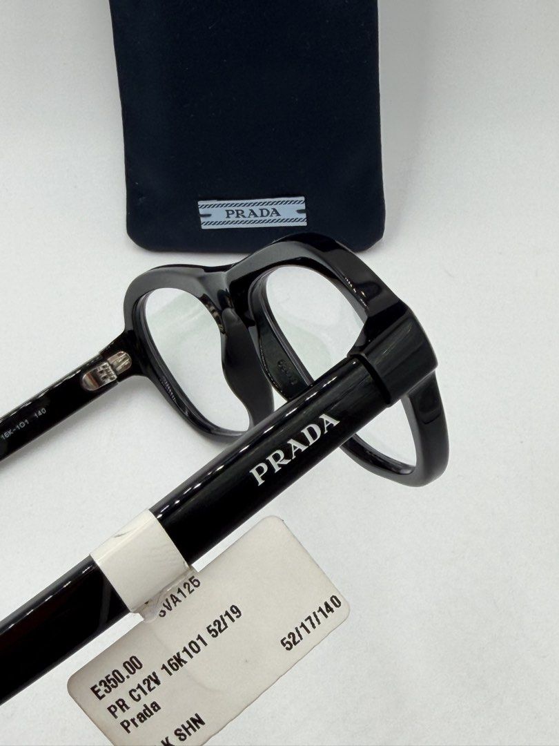 Prada PR C12V (VPRC12) eyeglasses, (Category: Activewear) located in Lipa City. Submitted by _cmluxephilippines (Listing ID 1470017579, Image 3). Description: Prada PR C12V (VPRC12) eyeglasses, • Design: A modern pillow or aviator/pilot-inspired shape that balances sharp structure with fluid, rounded curves. • Material: Crafted entirely from lightweight and durable polished black acetate. • Details: Subtle, elegant Prada logo lettering engraved a