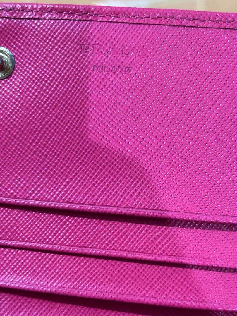 Prada Saffiano Leather Long Wallet Pink (Category: Luxury Bags & Wallets) located in Manila. Submitted by ruthbrightwater (Listing ID 1470021480, Image 3). Description: - Authentic Prada wallet in vibrant bright pink Saffiano leather - Elegant gold-tone hardware featuring the classic Milano front logo plaque - Convenient exterior zip pocket on the back - Secure snap button closure - Interior includes multiple card slots and compartments with Prad