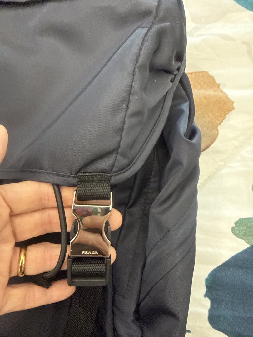 Prada Tessuto Montagn Backpack Bleu 2VZ062 (Category: Luxury Bags & Wallets) located in Makati City. Submitted by emeraldjade_star (Listing ID 1470139092, Image 3). Description: Authentic Prada Tessuto Montagne backpack in classic navy blue (Model 2VZ062). Made from durable nylon with silver-tone hardware and secure buckle closures. Clean and sturdy, complete with original tags, authenticity card, and paperwork..