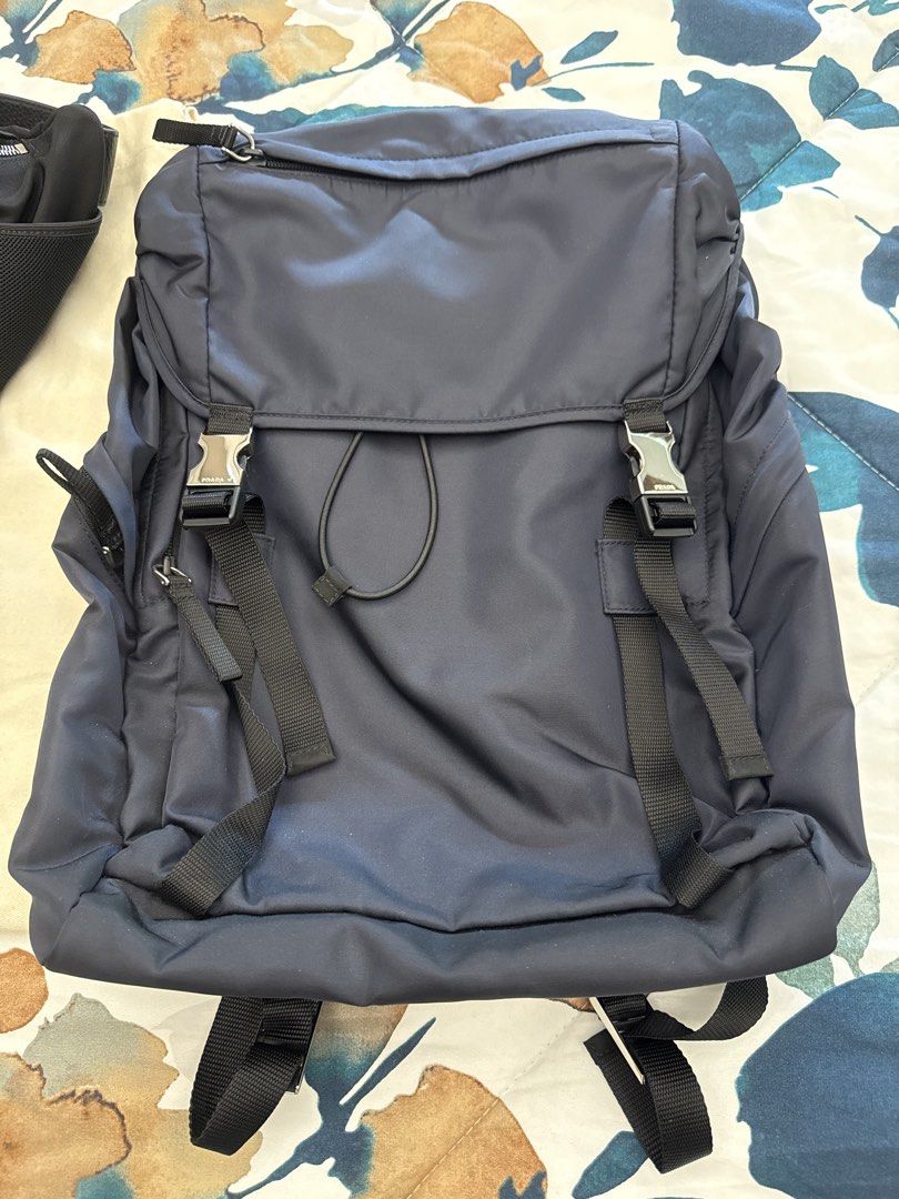 Prada Tessuto Montagn Backpack Bleu 2VZ062 (Category: Luxury Bags & Wallets) located in Makati City. Submitted by emeraldjade_star (Listing ID 1470139092, Image 2). Description: Authentic Prada Tessuto Montagne backpack in classic navy blue (Model 2VZ062). Made from durable nylon with silver-tone hardware and secure buckle closures. Clean and sturdy, complete with original tags, authenticity card, and paperwork..