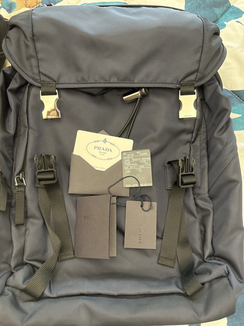 Prada Tessuto Montagn Backpack Bleu 2VZ062 (Category: Luxury Bags & Wallets) located in Makati City. Submitted by emeraldjade_star (Listing ID 1470139092, Image 1). Description: Authentic Prada Tessuto Montagne backpack in classic navy blue (Model 2VZ062). Made from durable nylon with silver-tone hardware and secure buckle closures. Clean and sturdy, complete with original tags, authenticity card, and paperwork..