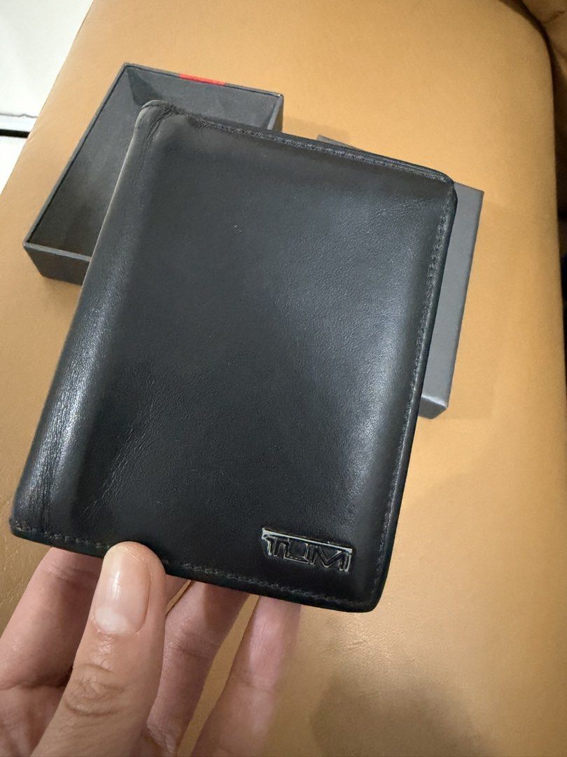 Pre-loved Authentic TUMI Black Leather Wallet with Box (Category: Wallets & Card Holders) located in Quezon City. Submitted by janabl (Listing ID 1470055890, Image 3). Description: - Pre-loved Authentic TUMI black leather wallet - Equipped with TUMI ID Lock RFID protection for security - Includes multiple card slots and a convenient ID window - Clean interior and exterior, ready to use - Comes with original box.