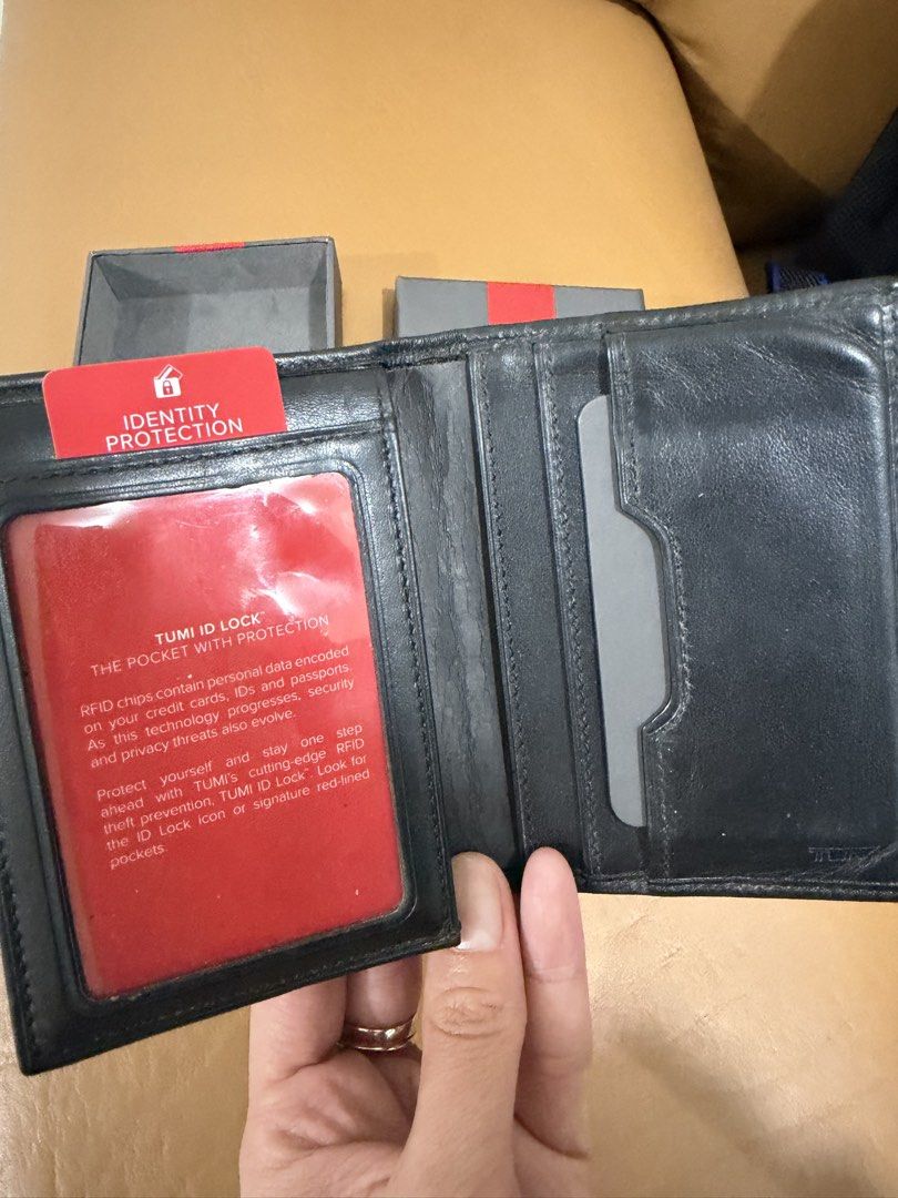 Pre-loved Authentic TUMI Black Leather Wallet with Box (Category: Wallets & Card Holders) located in Quezon City. Submitted by janabl (Listing ID 1470055890, Image 2). Description: - Pre-loved Authentic TUMI black leather wallet - Equipped with TUMI ID Lock RFID protection for security - Includes multiple card slots and a convenient ID window - Clean interior and exterior, ready to use - Comes with original box.