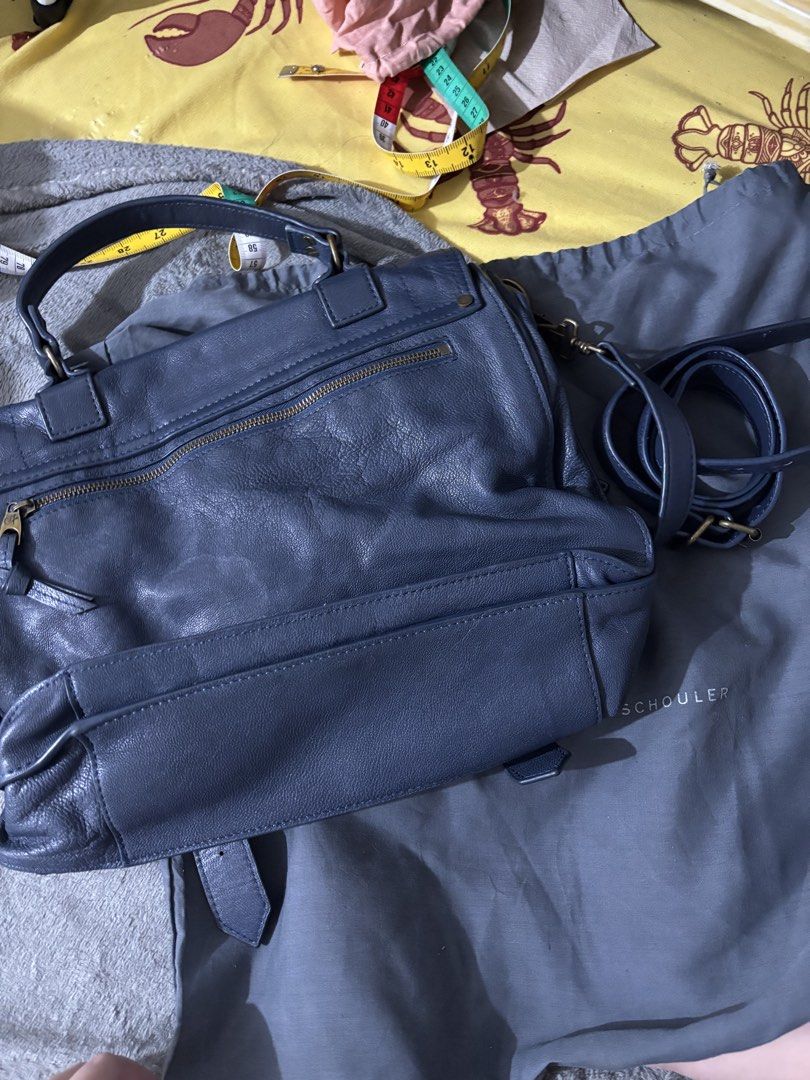 Proenza Schouler (Category: Cross-body Bags) located in Caloocan City. Submitted by rossvault2 (Listing ID 1469970026, Image 3). Description: Proenza Schouler shoulder bag in blue leather. Includes dust bag and matching detachable strap. Flap closure with metal hardware lock. Exterior back zip pocket and top handle. Supple textured leather material. Clean interior compartments and lining. Great everyday size. Ukay pl manage ur expectations .