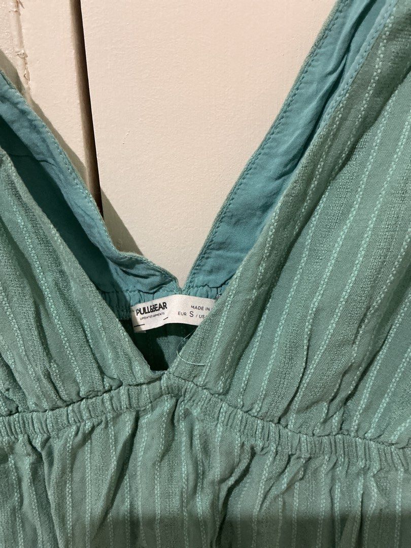 Pull & Bear Green V-Neck Mini Dress Size S (Category: Dresses) located in Rizal. Submitted by kyliemaine (Listing ID 1470036972, Image 2). Description: - Brand: Pull & Bear - Size: S - Design: Deep V-neckline with gathered underbust and textured striped fabric - Details: Tiered ruffle hem, sleeveless, lightweight with adjustable thin straps - Condition: Great casual piece, clean tag, smoke-free home.