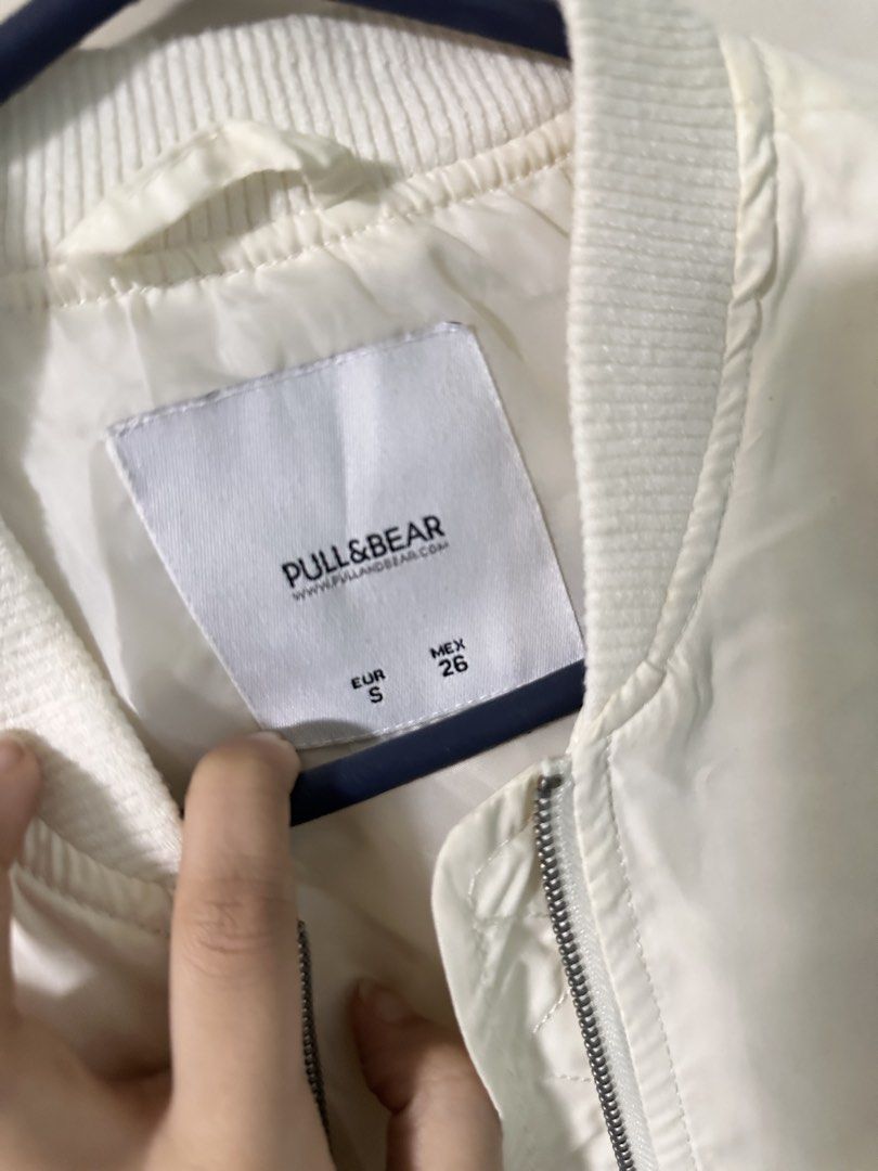 Pull & Bear White Bomber Jacket Size S (Category: Coats, Jackets and Outerwear) located in Quezon City. Submitted by bentabelles (Listing ID 1470120123, Image 2). Description: - Brand: Pull & Bear - Color: Clean White - Size: EUR S / MEX 26 - Design: Lightweight bomber jacket with ribbed collar, cuffs, and hem - Closure: Full front zipper - Pockets: Side pockets with snap buttons plus a zippered sleeve pocket - Style: Versatile piece that pairs e