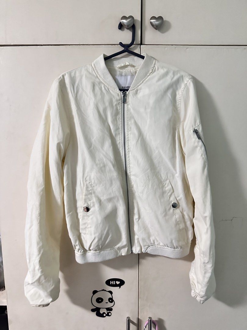 Pull & Bear White Bomber Jacket Size S (Category: Coats, Jackets and Outerwear) located in Quezon City. Submitted by bentabelles (Listing ID 1470120123, Image 1). Description: - Brand: Pull & Bear - Color: Clean White - Size: EUR S / MEX 26 - Design: Lightweight bomber jacket with ribbed collar, cuffs, and hem - Closure: Full front zipper - Pockets: Side pockets with snap buttons plus a zippered sleeve pocket - Style: Versatile piece that pairs e