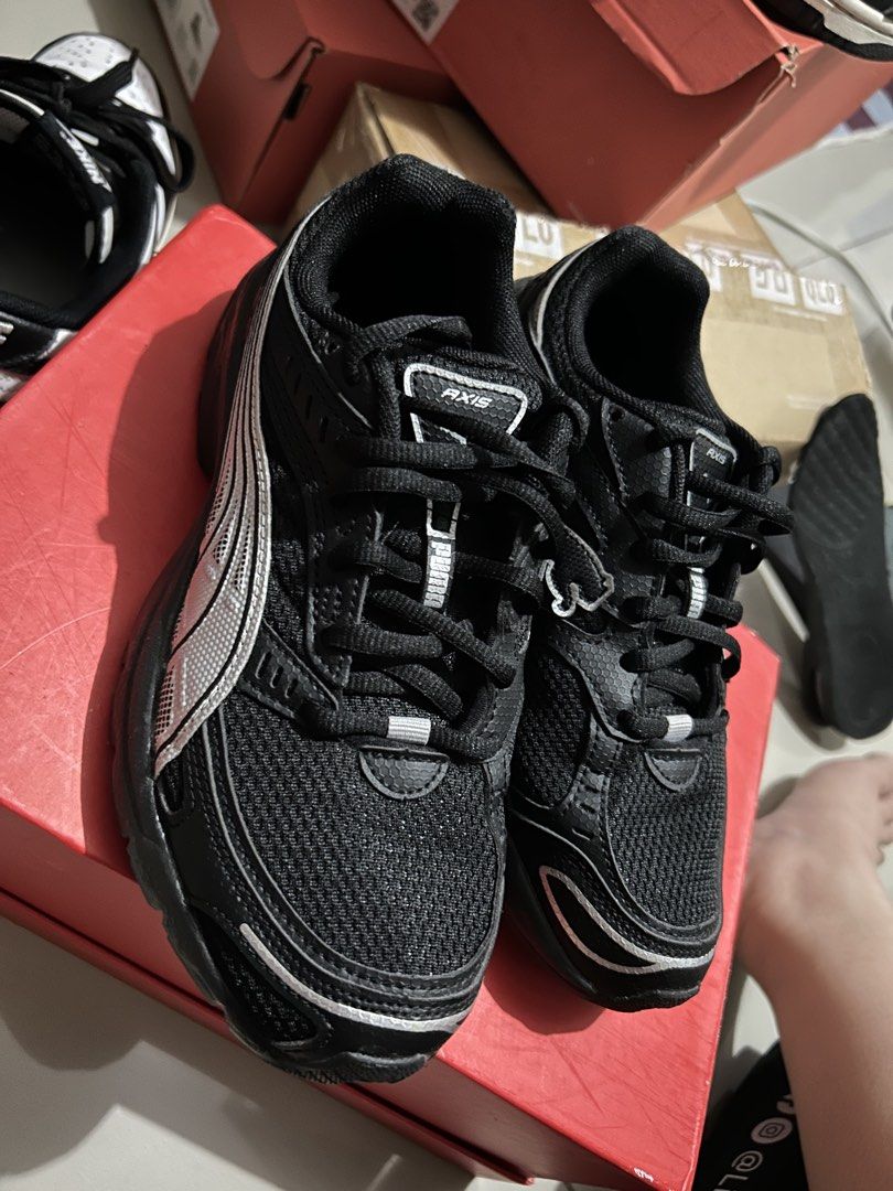 Puma Axis Black Silver Sneakers (Category: Sneakers) located in Quezon City. Submitted by jamsweetjam (Listing ID 1470037297, Image 2). Description: - Brand: Puma Axis Running Shoes - Color: Black with striking silver detailing - Size: UK 3.5 / US 4.5 / EUR 36 / 22.5 CM (refer to tongue tag) - Design: Trendy chunky sole with breathable mesh upper panels - Condition: Clean uppers and soles, well-maintained.