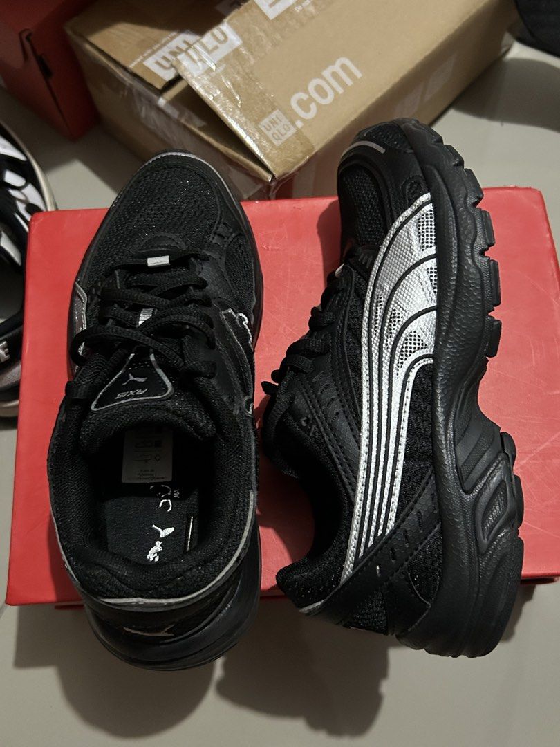 Puma Axis Black Silver Sneakers (Category: Sneakers) located in Quezon City. Submitted by jamsweetjam (Listing ID 1470037297, Image 1). Description: - Brand: Puma Axis Running Shoes - Color: Black with striking silver detailing - Size: UK 3.5 / US 4.5 / EUR 36 / 22.5 CM (refer to tongue tag) - Design: Trendy chunky sole with breathable mesh upper panels - Condition: Clean uppers and soles, well-maintained.