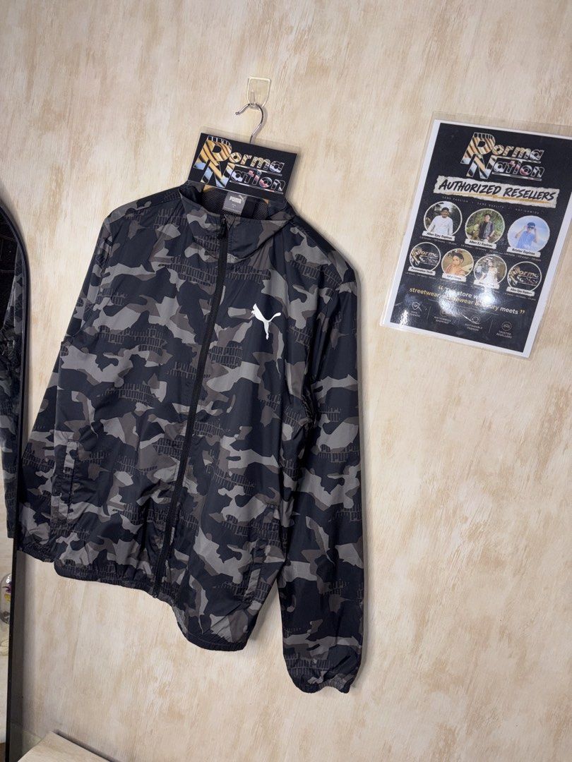 PUMA ESSENTIALS PRINTED CAMOU WINDBREAKER JACKET (Category: Coats, Jackets and Outerwear) located in Cabuyao City. Submitted by pormanation-thrift-store (Listing ID 1469991343, Image 3). Description: PUMA ESSENTIALS PRINTED CAMOU WINDBREAKER JACKET Condition: LIKE NEW Color rate: 10/10 (PWEDE SA MASELAN) Size: MEDIUM Dimes: 22”Wx27”L Issue: NONE‼️ Price: 1500.