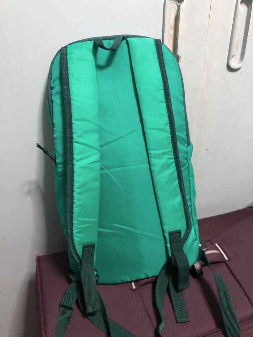 Quechua Green Backpack Daypack (Category: Backpacks) located in Manila. Submitted by blesslala (Listing ID 1470050781, Image 2). Description: - Brand: Quechua - Color: Green with dark green accents and a bright pink vertical front zipper pocket - Features: Adjustable green shoulder - Dimension :39 cm x 22 cm x 8 cm.