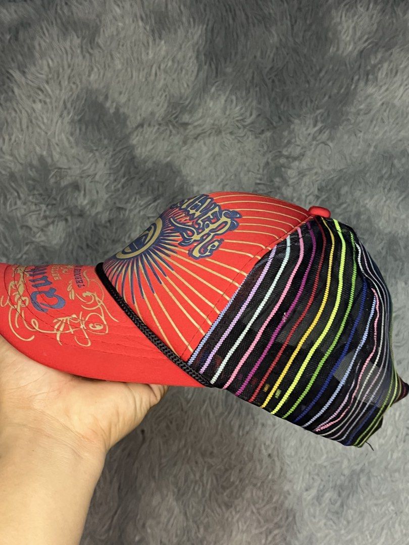Quiksilver Red Graphic Trucker Cap with Multi-color Mesh (Category: Caps & Hats) located in Muntinlupa City. Submitted by pastforwardthrift (Listing ID 1470125873, Image 3). Description: - Brand: Quiksilver - Color: Red with black mesh back - Design: Large front graphic logo with sunburst artwork and colourful vertical stripes on the back - Closure: Adjustable snapback - Condition: Clean brim, structured front panels, and interior tag intact.