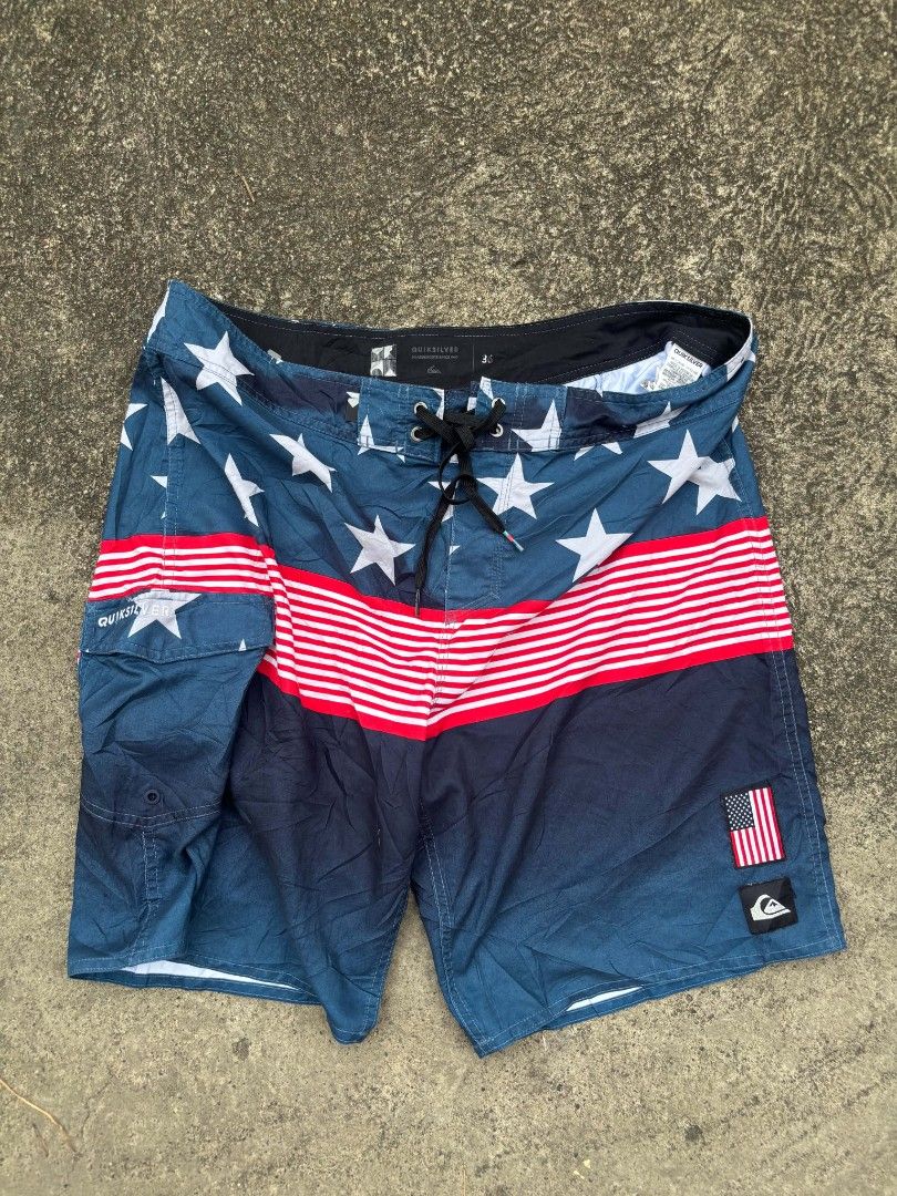 Quiksilver USA Flag Boardshorts Size 36 (Category: Swim Trunks & Board Shorts) located in Manila. Submitted by lawrence_escutin (Listing ID 1470001608, Image 1). Description: - Brand: Quiksilver - Style: American flag theme (stars, stripes, and solid dark blue) - Size: 36 (tagged on inner waistband) - Features: Side cargo pocket, secure drawstring waist with metal eyelets, and Quiksilver logo patch - Condition: Good, ready for the beach or pool -