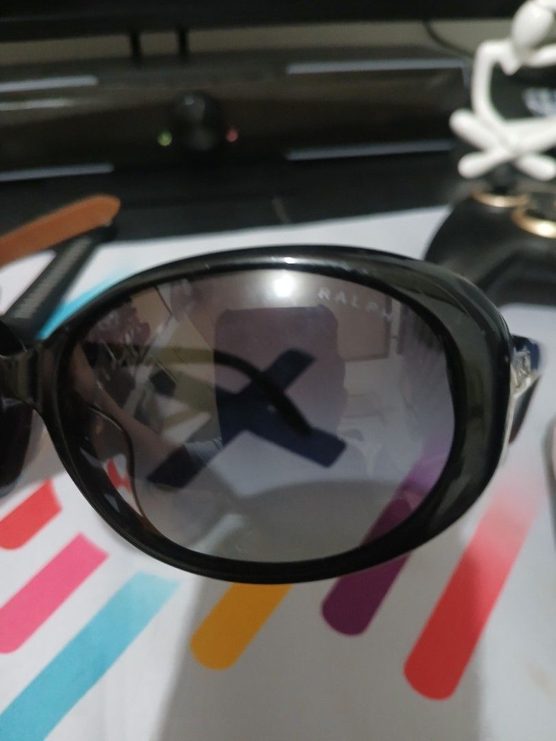 Ralph Lauren Black Sunglasses (Category: Sunglasses & Eyewear) located in Manila. Submitted by asianwave189184 (Listing ID 1470026030, Image 3). Description: - Brand: Ralph - Style: Classic oval shape - Color: Glossy black frames with dark tinted lenses - Details: Distinct Ralph branding on the temples - Fit: Solid build and comfortable for everyday wear - Ideal for: Sunny days out and outdoor activities.