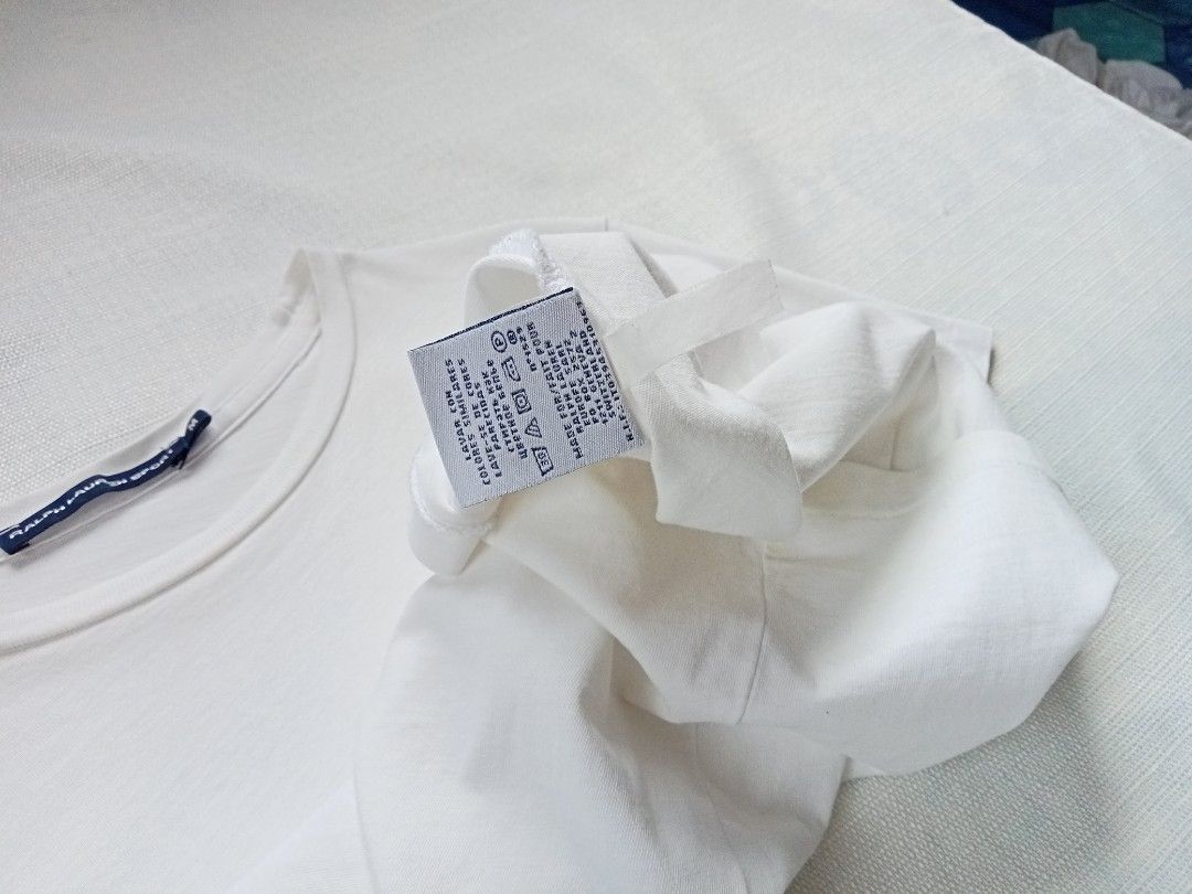 Ralph Lauren white roundneck tee for her (Category: Shirts) located in Bagabag. Submitted by thrift_stories96 (Listing ID 1470102718, Image 3). Description: Ralph Lauren white roundneck tee for her Small Length - 25 Width - 16.5 stretch up to 17 Condition - 8.5/10 Flaw - fade yellow stain on some parts,not noticeable when worn saka lang mapapansin pag titignan ng malapitan.Needs more washing.