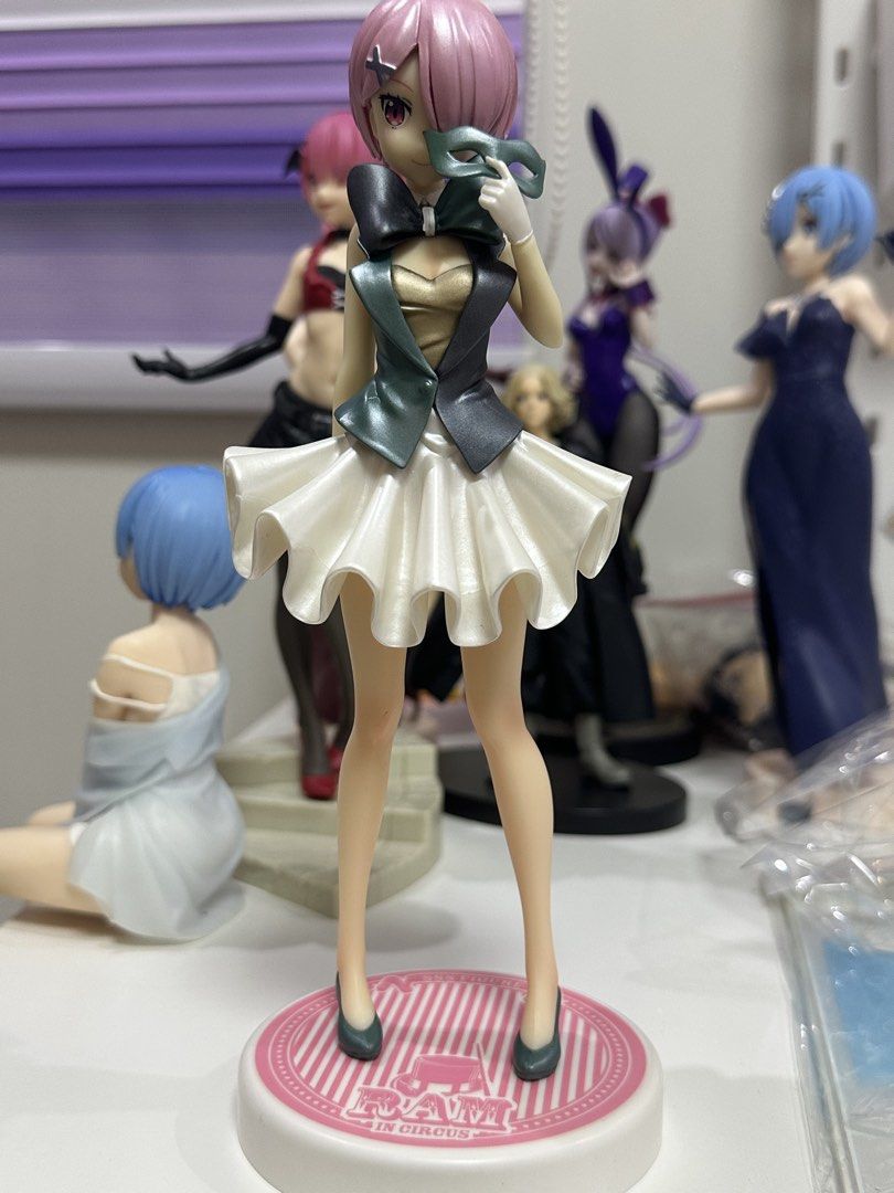 Ram In Circus Anime Figure Re:Zero (Category: Figurines & Statues) located in Manila. Submitted by silentfire.54ea36 (Listing ID 1470115819, Image 1). Description: - Character: Ram from Re:Zero - Line: SSS Figure (Circus Theme) - Details: Pink hair, holding a green mask, dark vest, and flared white skirt - Base: Pink and white striped circular base with 'RAM IN CIRCUS' text - Condition: Authentic and display-ready figure.