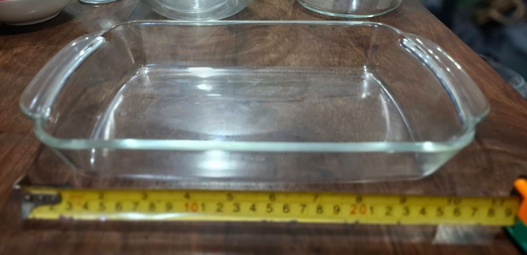 Rectangular Glass Baking Dish (Category: Bakeware) located in Pasig City. Submitted by dripcounty (Listing ID 1470024530, Image 1). Description: Rectangular Glass Baking Dish ₱200 Bought in the Philippines Condition: Good / preloved Clear rectangular glass dish with side handles. See measuring tape in photo for approximate size. Brand unconfirmed. Actual item shown in photos. Delivery fee shouldered by buyer (Lalamove / other courier). Item price