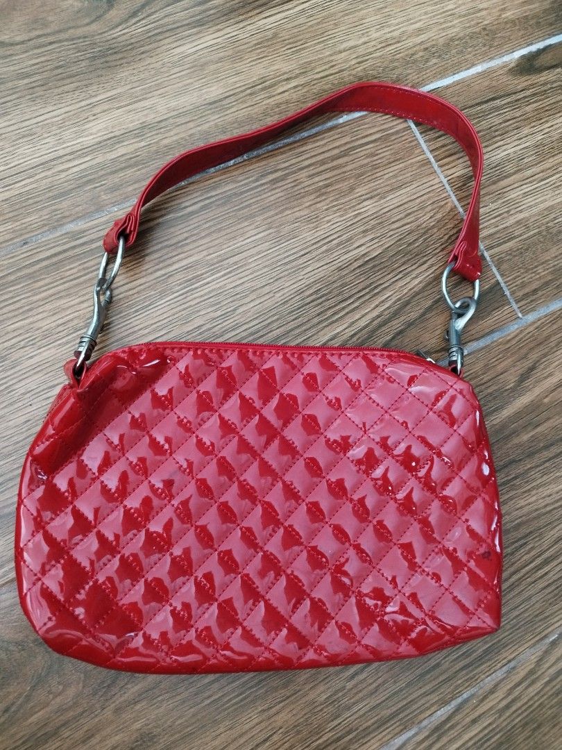 Red Quilted Patent Leather Handbag (Category: Luxury Bags & Wallets) located in Cavite. Submitted by RAJATREASUREBOX (Listing ID 1469991533, Image 1). Description: - Color/Material: Bright red glossy patent leather - Design: Quilted diamond pattern with silver hardware - Closure: Secure top zipper - Strap: Matching red strap with silver metal clasps - Size: Compact, ideal for daily essentials - Condition: Good, with a minor dark scuff mark near t