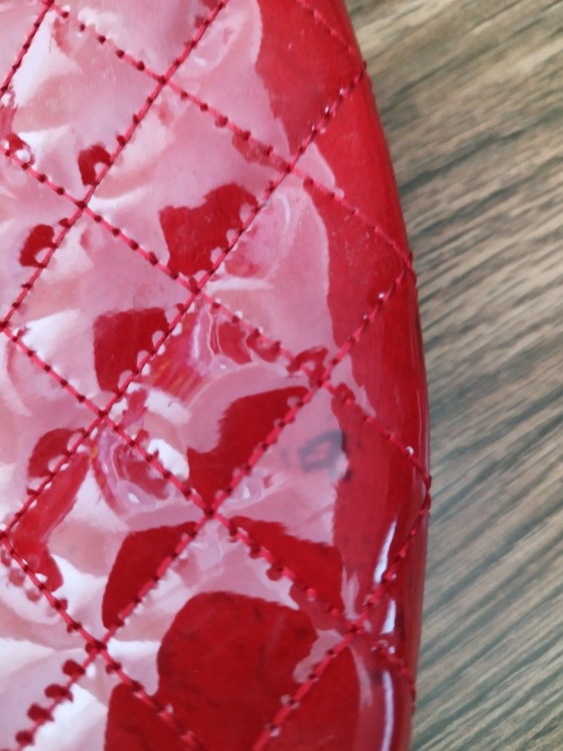 Red Quilted Patent Leather Handbag (Category: Luxury Bags & Wallets) located in Cavite. Submitted by RAJATREASUREBOX (Listing ID 1469991533, Image 2). Description: - Color/Material: Bright red glossy patent leather - Design: Quilted diamond pattern with silver hardware - Closure: Secure top zipper - Strap: Matching red strap with silver metal clasps - Size: Compact, ideal for daily essentials - Condition: Good, with a minor dark scuff mark near t