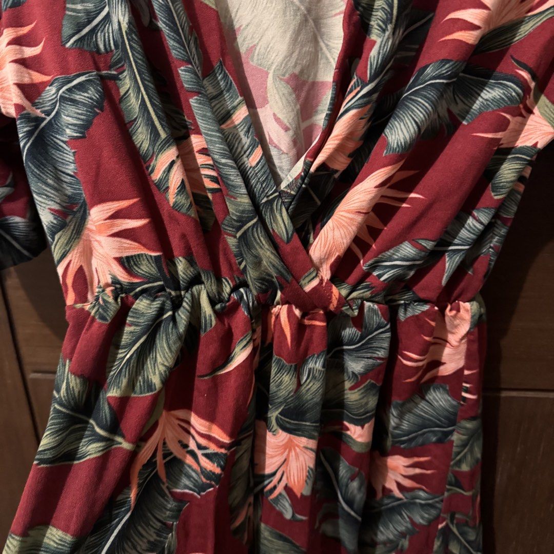 Red Tropical Leaf Print V-Neck Romper (Category: Rompers) located in Quezon City. Submitted by ianne.declutter (Listing ID 1469975388, Image 2). Description: - Vibrant red romper with tropical leaf and bird of paradise print - Flattering crossover V-neck and short sleeves - Comfortable elastic waist for a great fit - Lightweight fabric, ideal for warm weather and beach trips - Easy slip-on style.