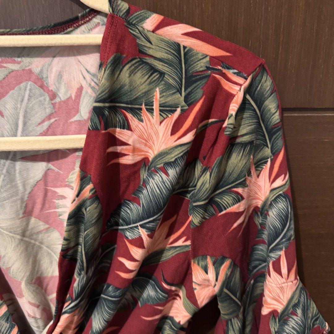 Red Tropical Leaf Print V-Neck Romper (Category: Rompers) located in Quezon City. Submitted by ianne.declutter (Listing ID 1469975388, Image 3). Description: - Vibrant red romper with tropical leaf and bird of paradise print - Flattering crossover V-neck and short sleeves - Comfortable elastic waist for a great fit - Lightweight fabric, ideal for warm weather and beach trips - Easy slip-on style.