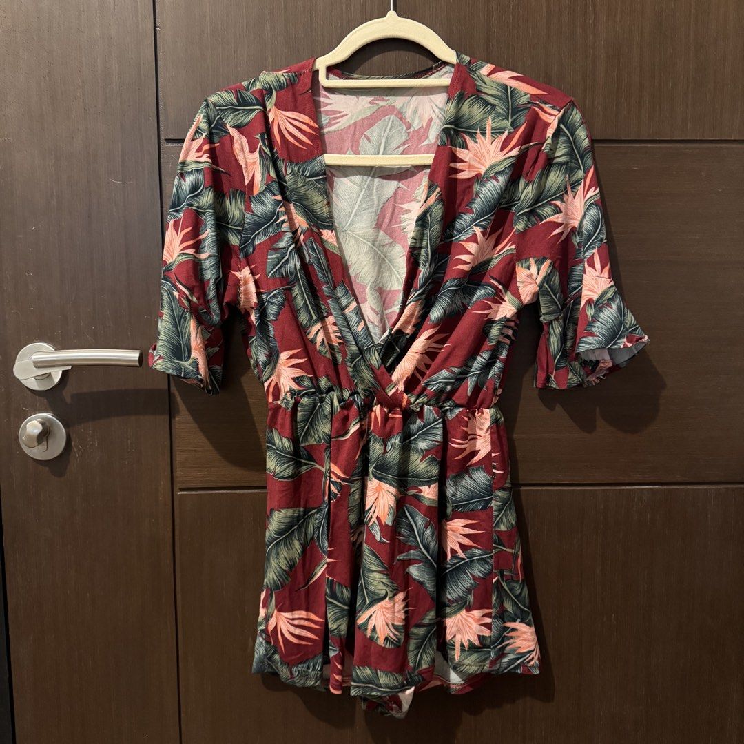 Red Tropical Leaf Print V-Neck Romper (Category: Rompers) located in Quezon City. Submitted by ianne.declutter (Listing ID 1469975388, Image 1). Description: - Vibrant red romper with tropical leaf and bird of paradise print - Flattering crossover V-neck and short sleeves - Comfortable elastic waist for a great fit - Lightweight fabric, ideal for warm weather and beach trips - Easy slip-on style.