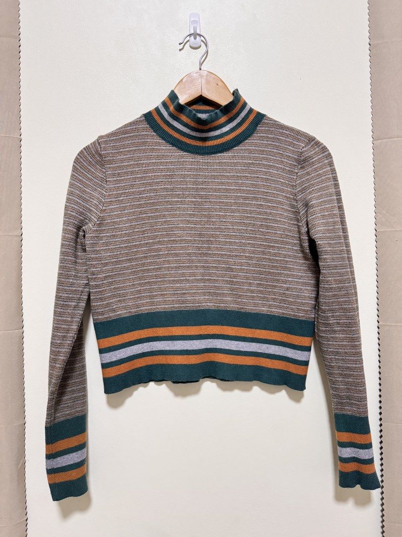 Retro Striped Mock Neck Cropped Sweater (Category: Longsleeves) located in Manila. Submitted by seayouncey (Listing ID 1470046900, Image 1). Description: - Colorway: Vintage retro stripes in brown, green, orange, and grey - Fit: Cropped length with long sleeves - Details: Mock neck with ribbed collar, cuffs, and hem - Material: Fine knit fabric with horizontal stripe pattern - Style: Great layering piece for cooler weather.
