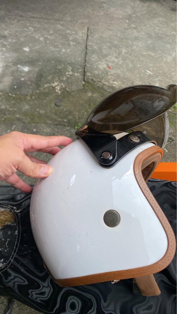Retro White Open Face Helmet with Visor Size XL (Category: Caps & Hats) located in Manila. Submitted by drake21_mountain (Listing ID 1469977726, Image 3). Description: - Type: Open face motorcycle helmet - Color/Style: White shell with stylish brown trim and inner padding - Size: XL (tagged at the back) - Visor: Dark tinted bubble visor included (snap-on) - Closure: Red quick-release buckle (fully functional) - Condition: Outer shell has normal u