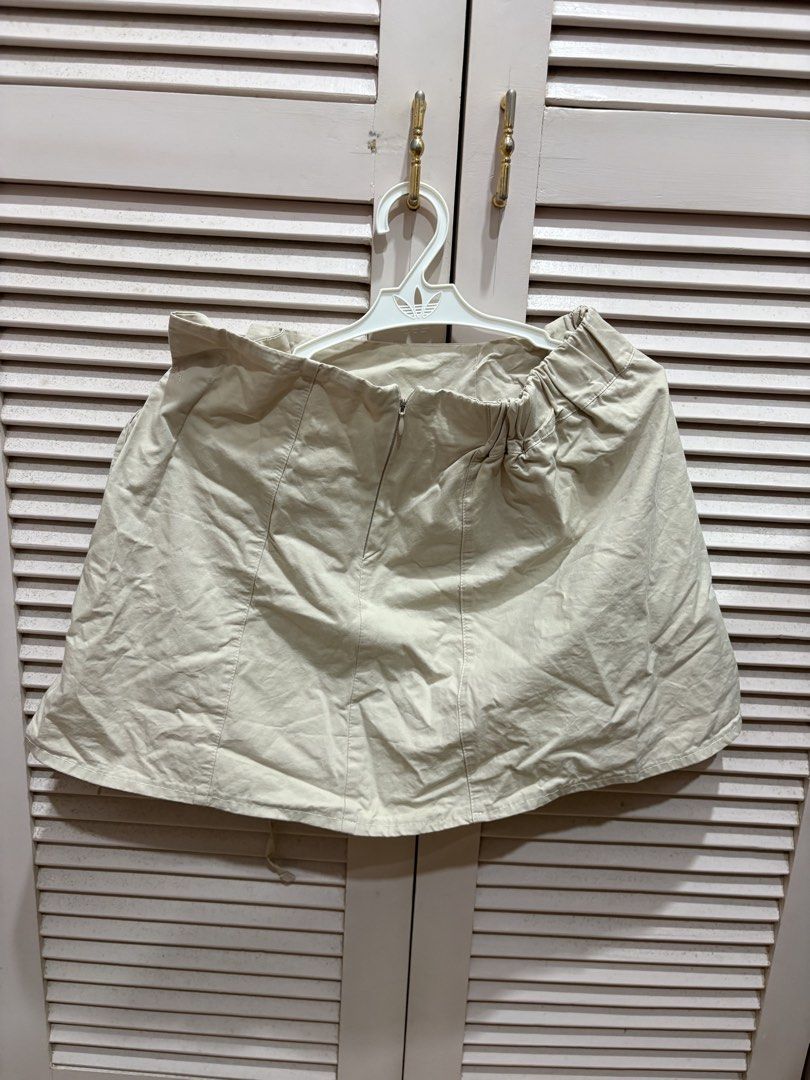 Reworked Beige Mini Skirt (Category: Skirts) located in Muntinlupa City. Submitted by sukimum (Listing ID 1469975237, Image 2). Description: Bought this item on IG as part of a set. Used once only, would wear more if it fit me better. It fits petite girls best (XS-S). The gartered back and front tie are suuuper cute even with just a white shirt. Great for summer and easy to layer!.