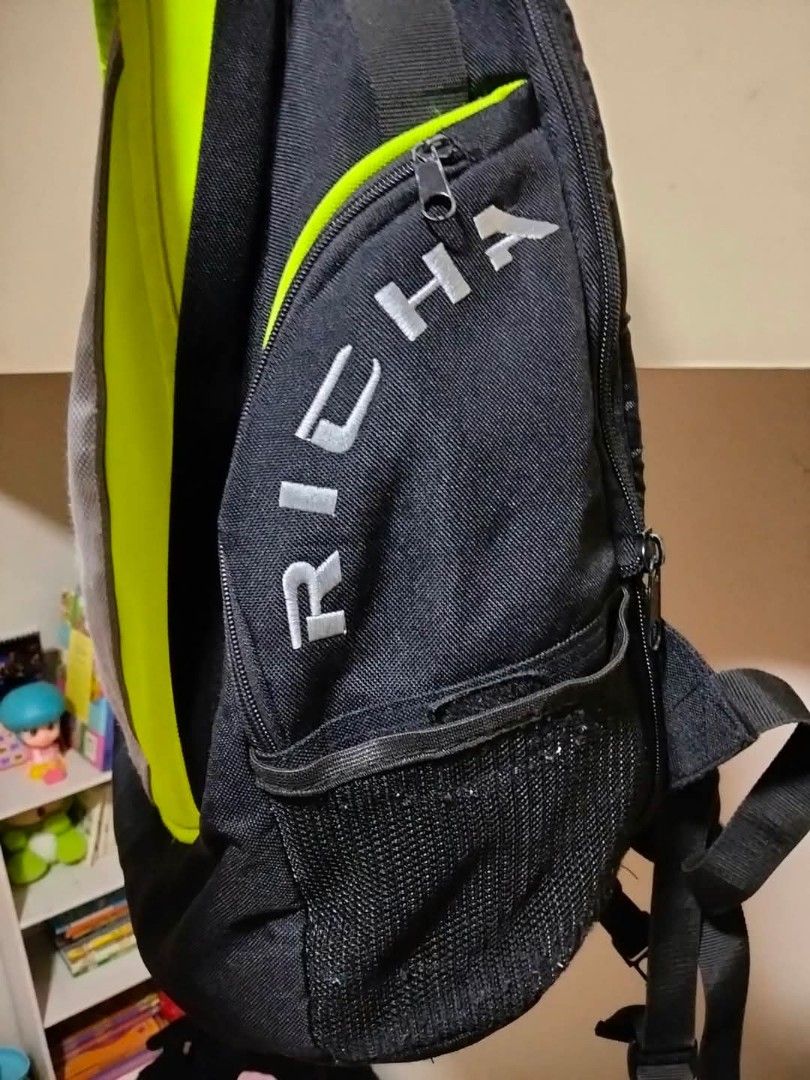 Richa Black and Neon Green Backpack (Category: Backpacks) located in Mangaldan. Submitted by niftythrifty69 (Listing ID 1470053654, Image 2). Description: - Brand: Richa - Color: Black with bright neon green panels and reflective silver strip - Storage: Good capacity with multiple internal compartments and organizer slots - Pockets: Convenient mesh side pockets - Comfort: Adjustable shoulder straps and sturdy top handle - Ideal for: Daily commute