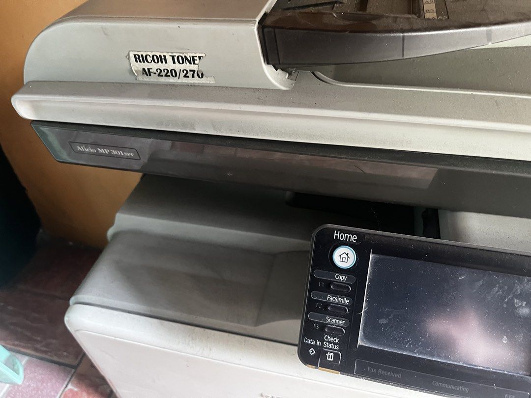 Ricoh Aficio MP 301SPF Multifunction Printer Copier defective (Category: Printers, Scanners & Copiers) located in Manila. Submitted by charles.carlcustomizedshop (Listing ID 1469957031, Image 2). Description: - Model: Ricoh Aficio MP 301SPF multifunction printer - Functions: Print, copy, and scan - Features: Touchscreen control panel, number keypad, standard bottom paper tray, and top document feeder - Condition: Heavy-duty office machine, works 